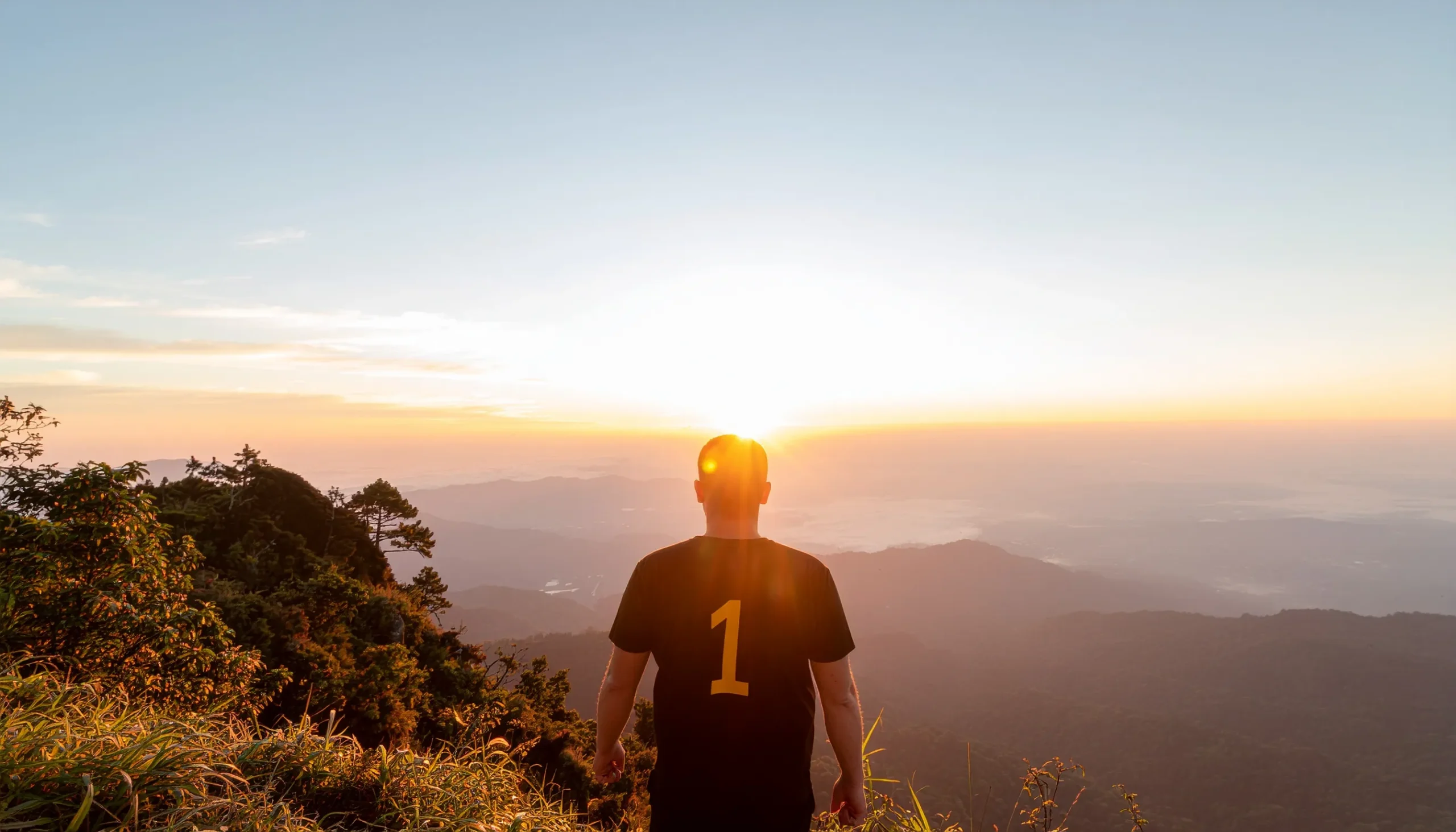 Destiny Number 1 in numerology — a confident leader standing at sunrise representing leadership, independence, and new beginnings